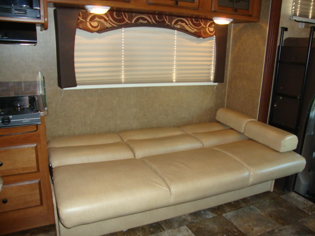 The Coachmen 320BH Class C Bunkhouse is equipped with a comfortable sofa set, providing a cozy seating area for relaxing or entertaining