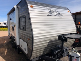 Exterior view of a travel trailer, highlighting its design, structure, and any visible features such as windows and doors